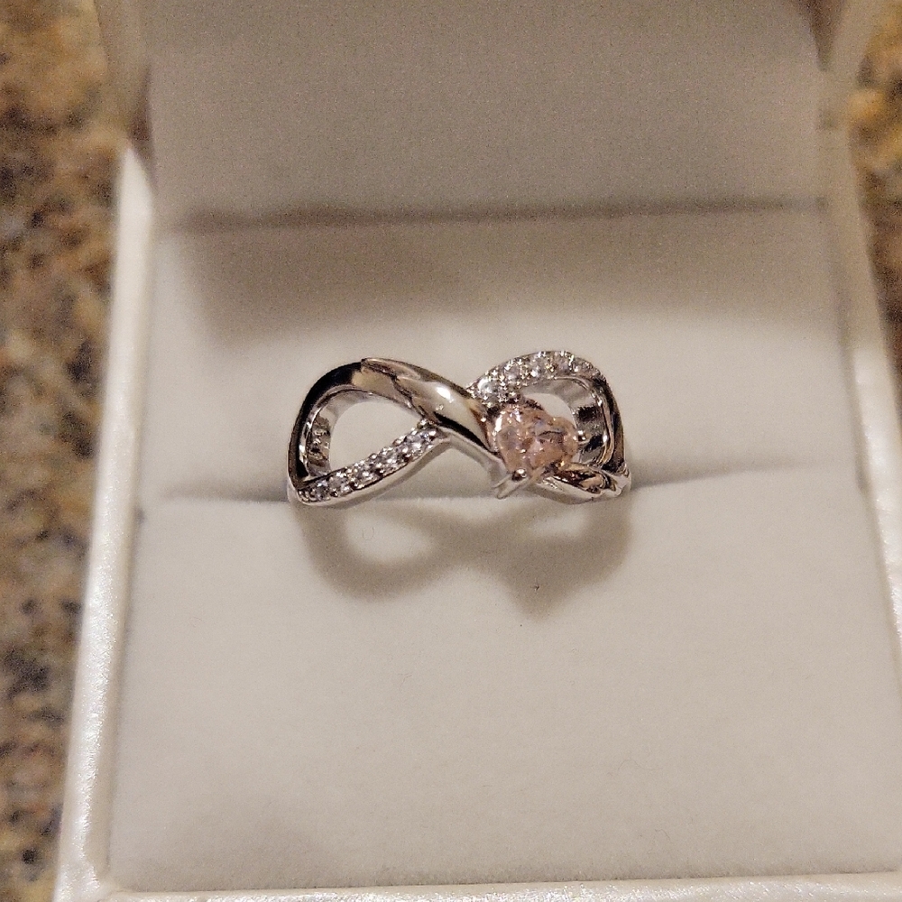 Elegant Silver Infinity Ring with Pink Accent